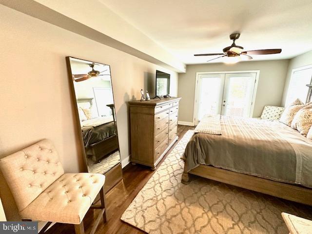 1 E Essex St, Fenwick Island, DE 19944 - bedroom featuring french doors, access to outside, dark wood finished floors, baseboards, and ceiling fan