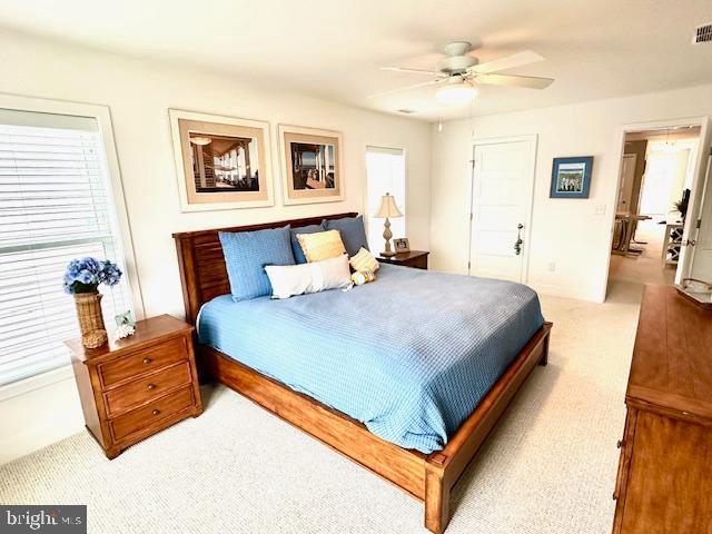 1 E Essex St, Fenwick Island, DE 19944 - bedroom featuring light carpet and a ceiling fan