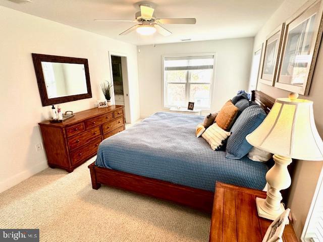 1 E Essex St, Fenwick Island, DE 19944 - carpeted bedroom with a ceiling fan and baseboards