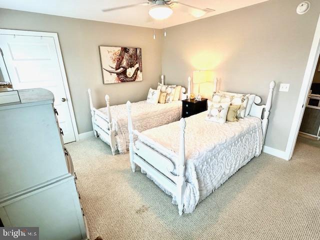 1 E Essex St, Fenwick Island, DE 19944 - bedroom featuring light carpet, baseboards, and a ceiling fan