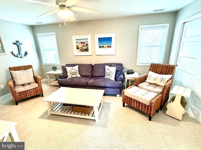 1 E Essex St, Fenwick Island, DE 19944 - carpeted living room featuring ceiling fan