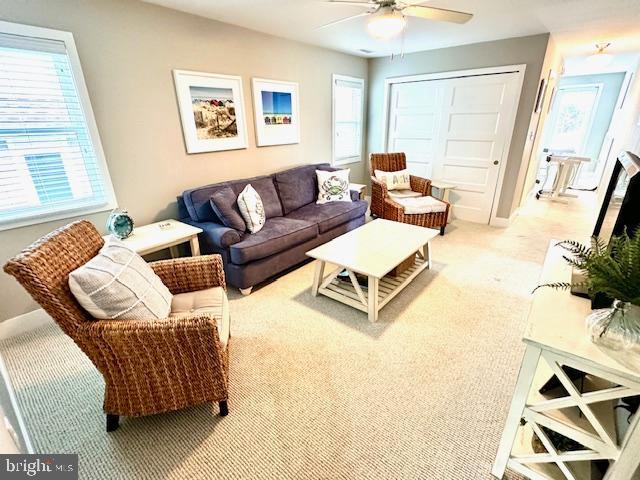 1 E Essex St, Fenwick Island, DE 19944 - living room with a ceiling fan, plenty of natural light, and carpet floors