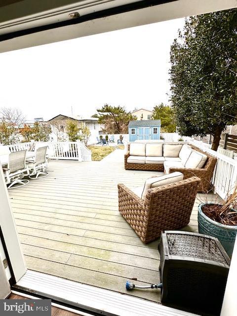 1 E Essex St, Fenwick Island, DE 19944 - wooden terrace with outdoor lounge area and outdoor dining space