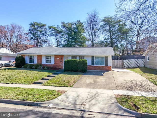 single story home featuring a front yard, concrete driveway, fence, and brick siding