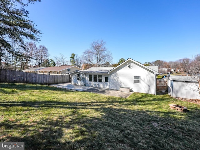 back of house with a lawn, a fenced backyard, and a patio area