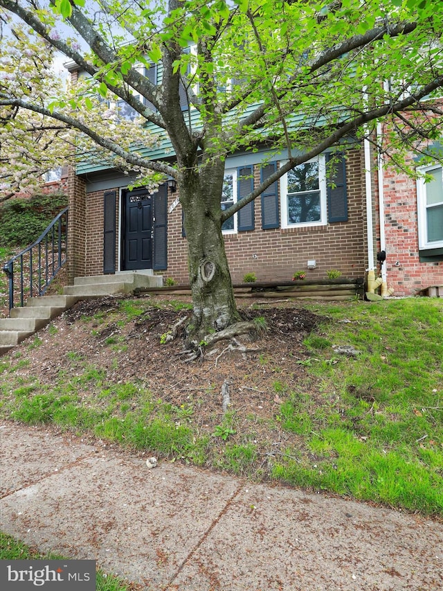 view of front of home featuring brick siding