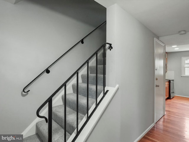 stairs with baseboards and wood finished floors