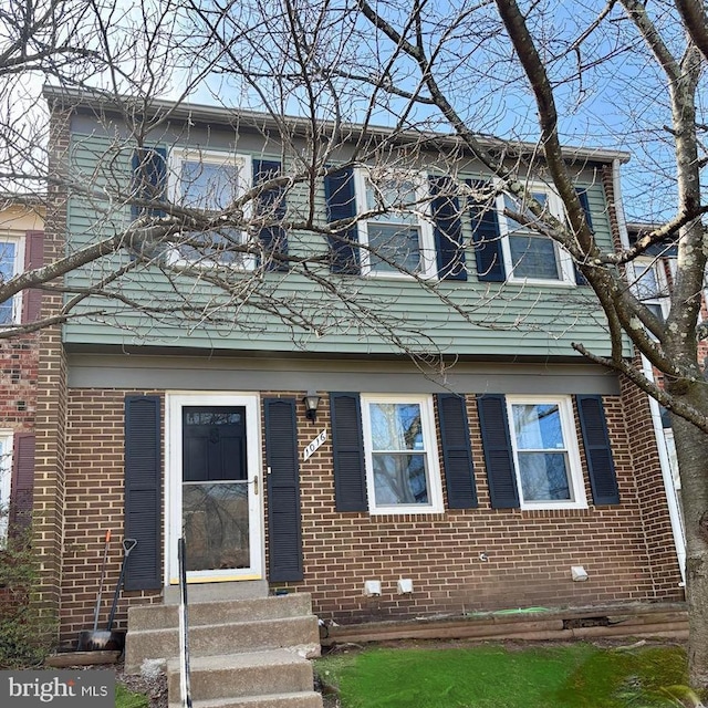 view of front of home featuring brick siding and entry steps