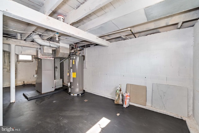 below grade area featuring heating unit, concrete block wall, and water heater