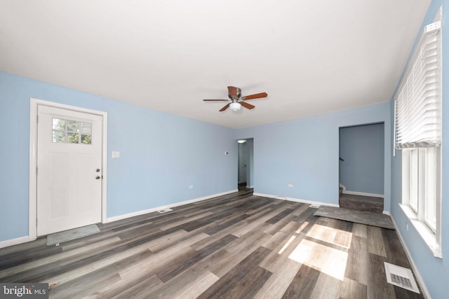 unfurnished living room with visible vents, baseboards, ceiling fan, and wood finished floors