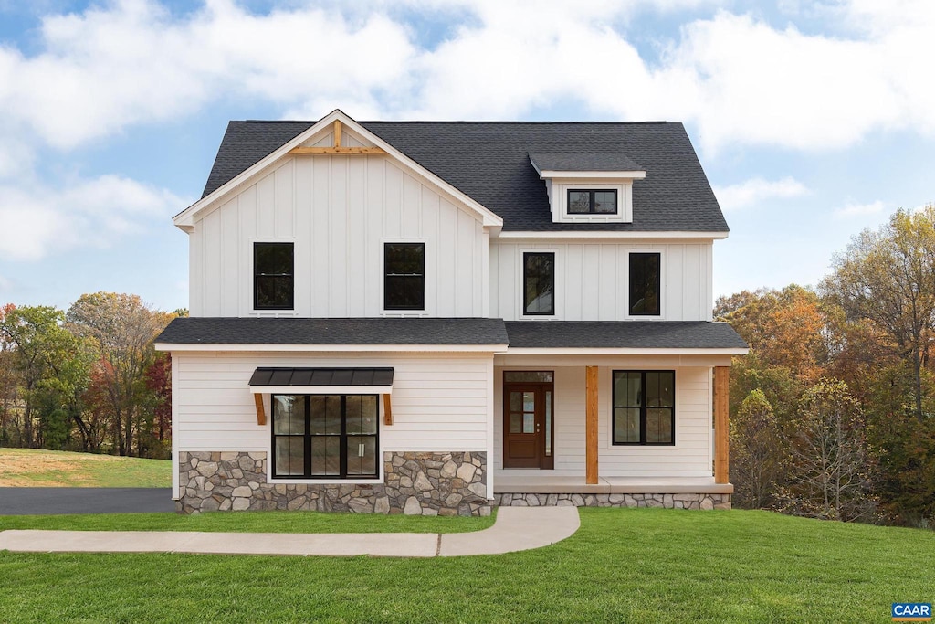 modern farmhouse with a front lawn, a porch, board and batten siding, and a shingled roof