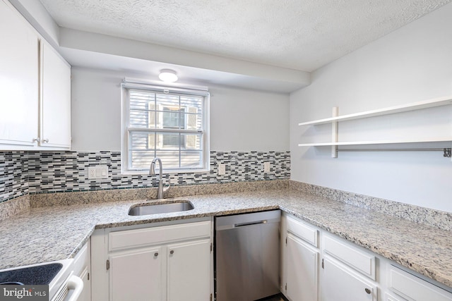 kitchen featuring dishwasher, white cabinets, backsplash, and a sink