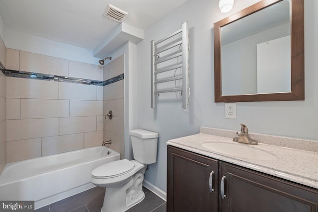 full bathroom featuring visible vents, radiator, washtub / shower combination, toilet, and vanity