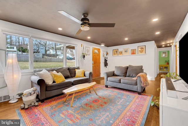 living room featuring a ceiling fan, recessed lighting, and wood finished floors