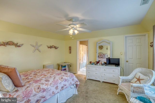 carpeted bedroom with visible vents and ceiling fan