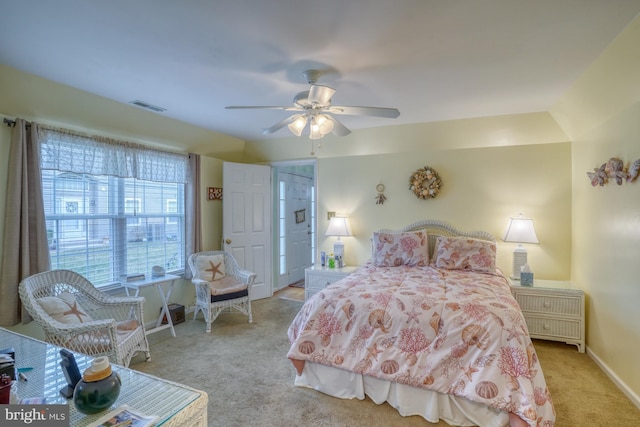 carpeted bedroom with visible vents, baseboards, and ceiling fan