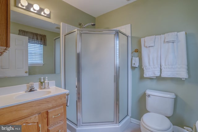 full bathroom with vanity, toilet, and a stall shower