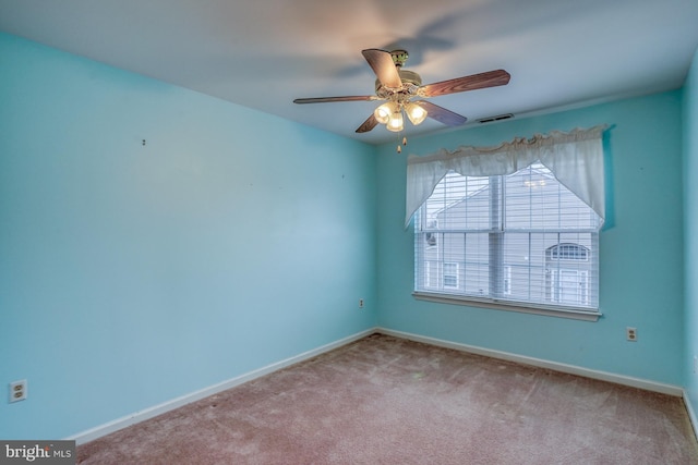 unfurnished room featuring visible vents, baseboards, a ceiling fan, and carpet floors