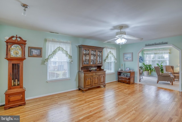 interior space with light wood-style flooring, plenty of natural light, a ceiling fan, and visible vents