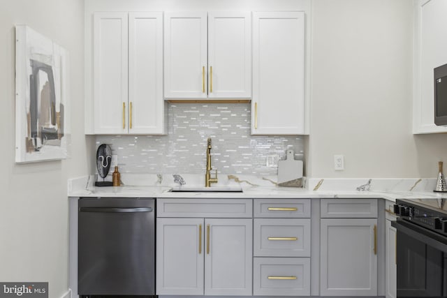 kitchen with gray cabinetry, a sink, stainless steel dishwasher, backsplash, and stove