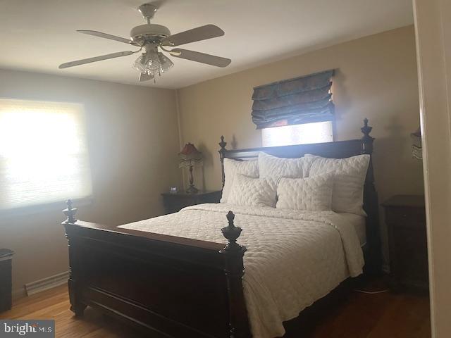 bedroom featuring a ceiling fan and wood finished floors