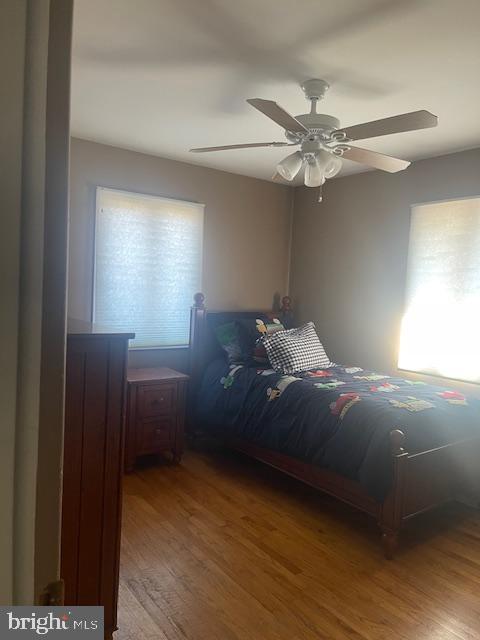 unfurnished bedroom with a ceiling fan and wood finished floors