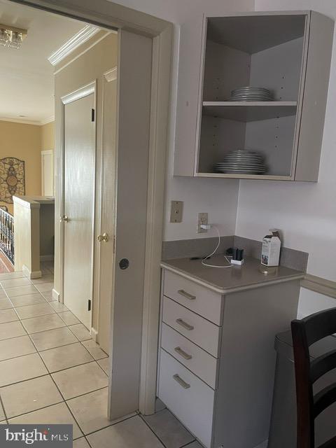 interior space featuring tile patterned flooring and crown molding