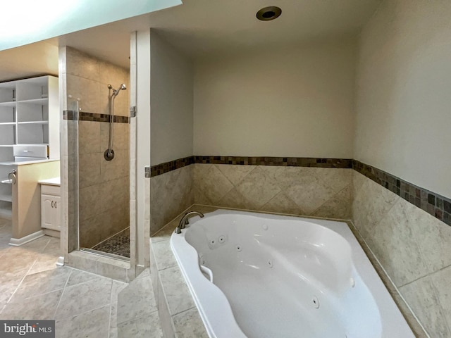 full bath featuring tile patterned floors, a tub with jets, a stall shower, and vanity