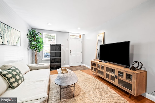 living area with recessed lighting, wood finished floors, and baseboards