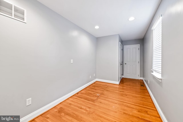 empty room with recessed lighting, visible vents, light wood-style flooring, and baseboards