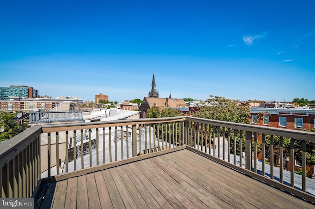 wooden terrace featuring a city view