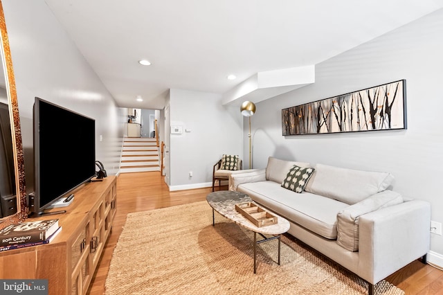 living area featuring stairway, light wood-style flooring, recessed lighting, and baseboards