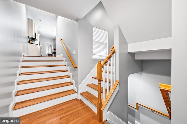 stairs featuring baseboards and wood finished floors