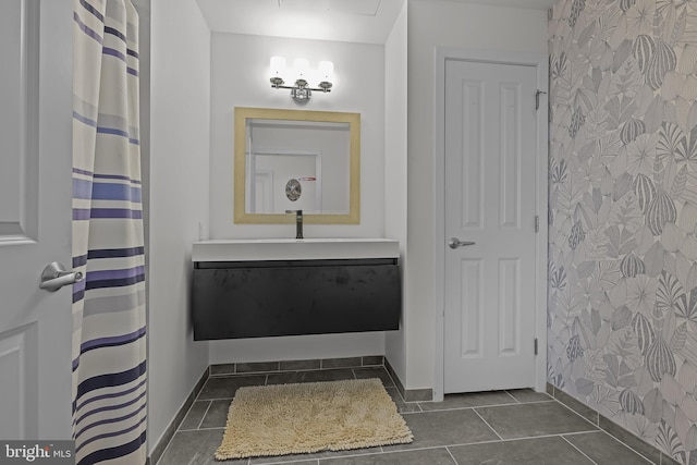 bathroom featuring vanity, baseboards, and tile patterned flooring