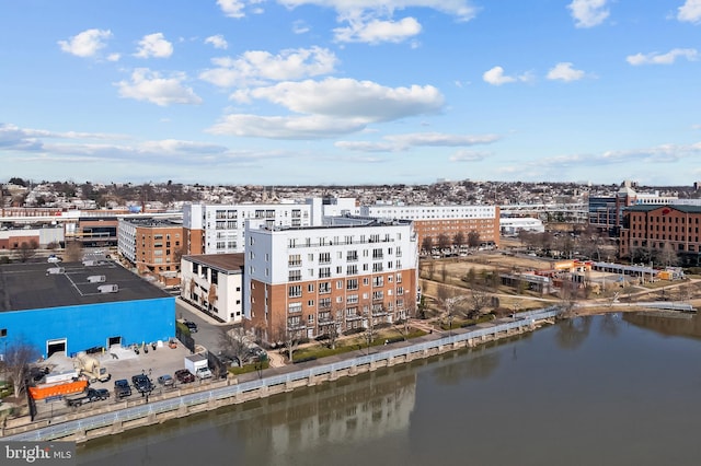 birds eye view of property with a water view and a view of city