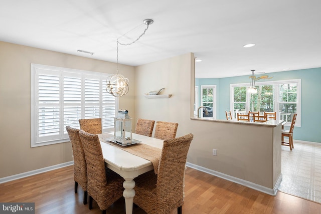 dining room featuring visible vents, recessed lighting, light wood-style floors, baseboards, and a chandelier