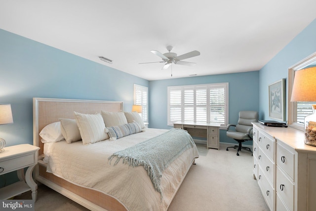 bedroom featuring ceiling fan, visible vents, and light carpet