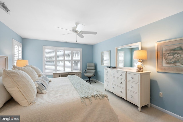 bedroom featuring visible vents, multiple windows, light colored carpet, and baseboards