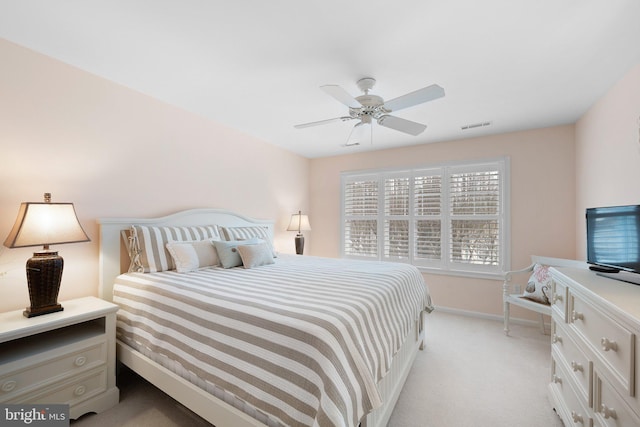 bedroom with ceiling fan, light colored carpet, visible vents, and baseboards