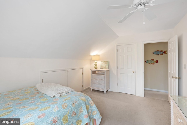 bedroom featuring vaulted ceiling, carpet flooring, baseboards, and ceiling fan