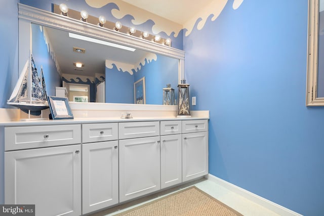 bathroom with vanity and baseboards