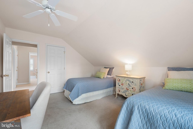 bedroom with a ceiling fan, lofted ceiling, and carpet floors