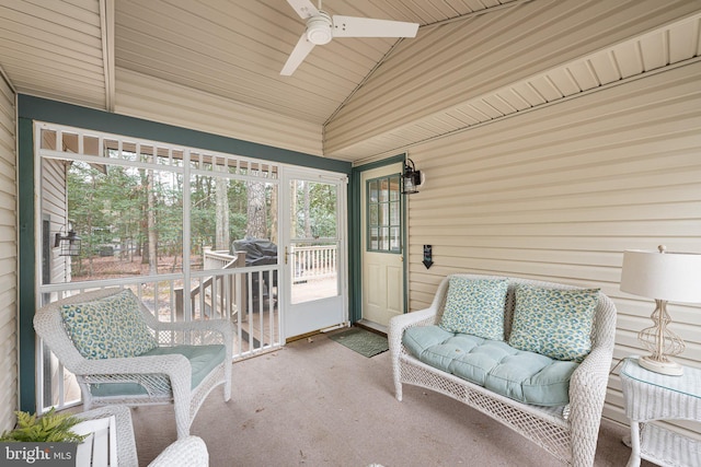 sunroom / solarium featuring plenty of natural light, ceiling fan, and vaulted ceiling with beams