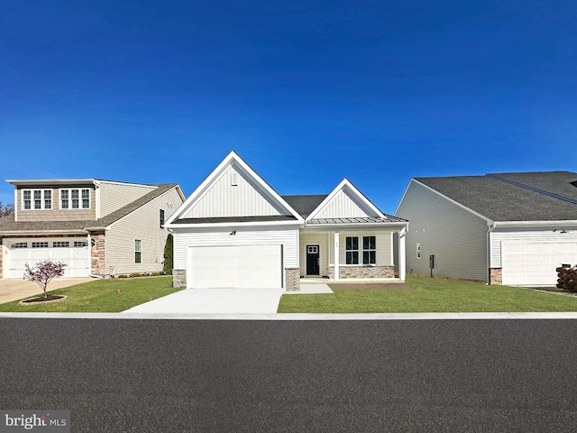 view of front of home with board and batten siding, a front lawn, a porch, stone siding, and driveway