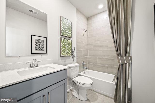 full bath with visible vents, toilet, vanity, and shower / bathtub combination with curtain