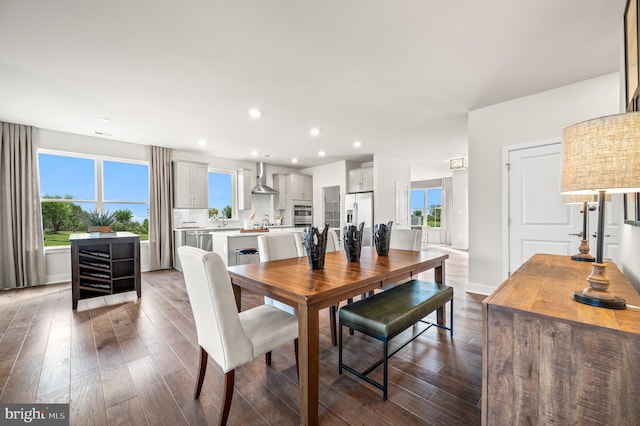 dining area featuring recessed lighting, baseboards, and dark wood-style flooring