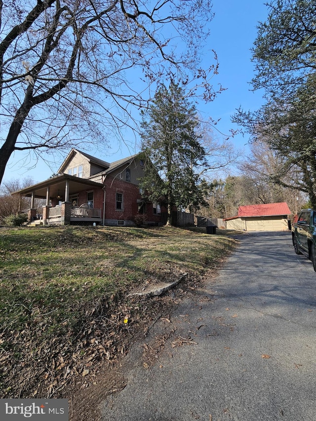 view of property exterior with a yard and a porch