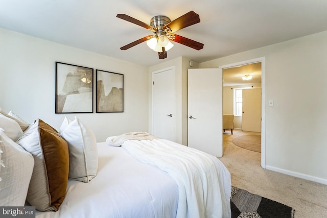 bedroom with carpet flooring, a ceiling fan, and baseboards