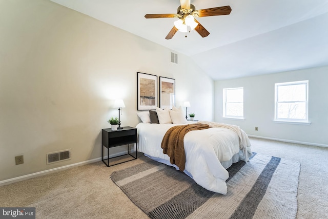 carpeted bedroom with visible vents, baseboards, and vaulted ceiling