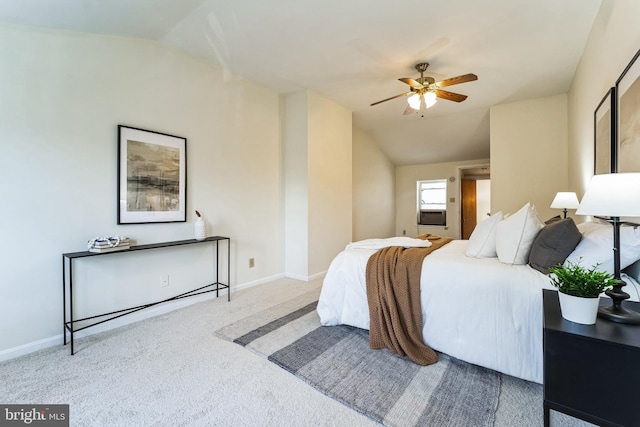 carpeted bedroom with baseboards and lofted ceiling